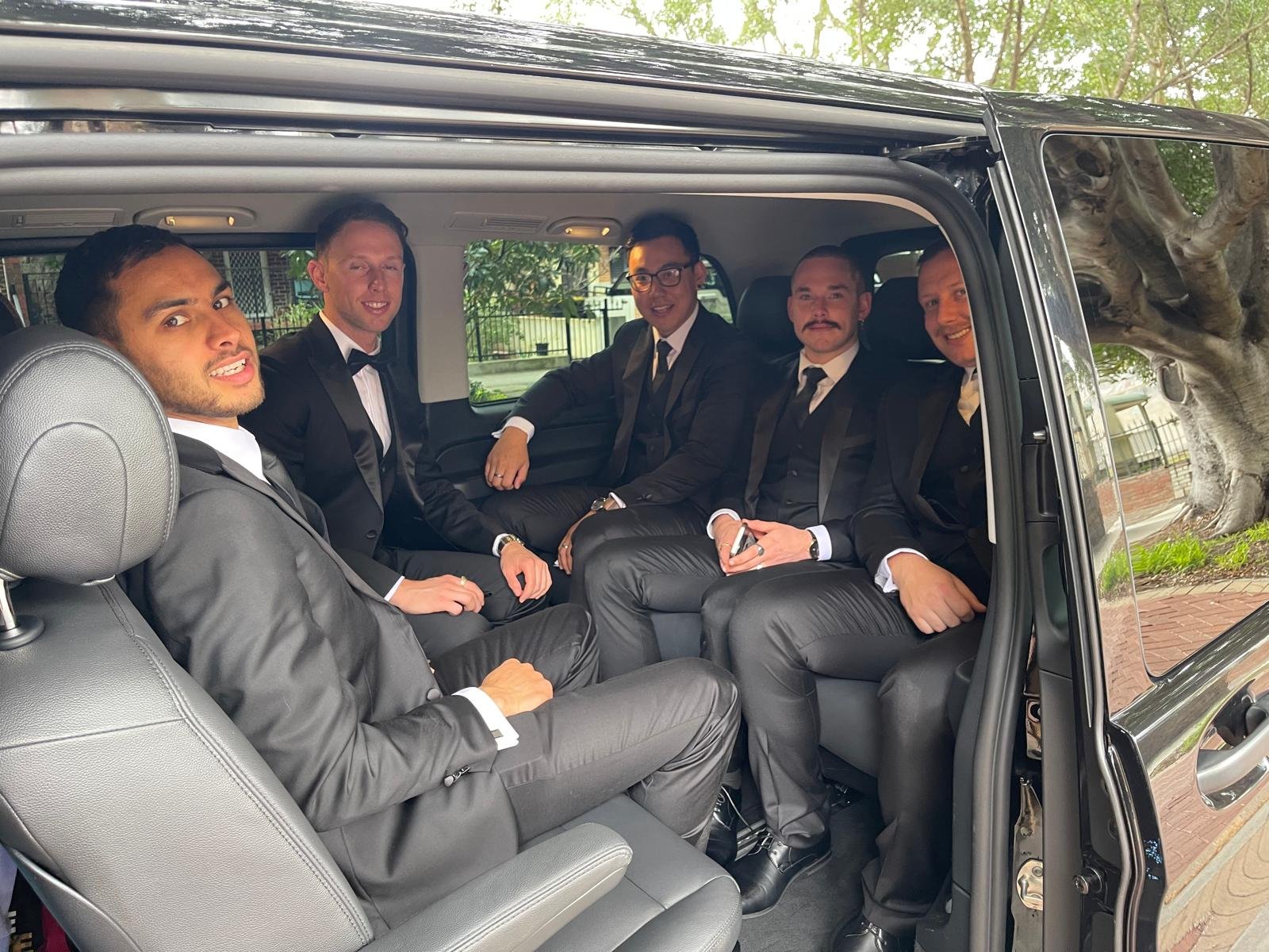 Five men in suits inside black van | ichauffeurmelbourne