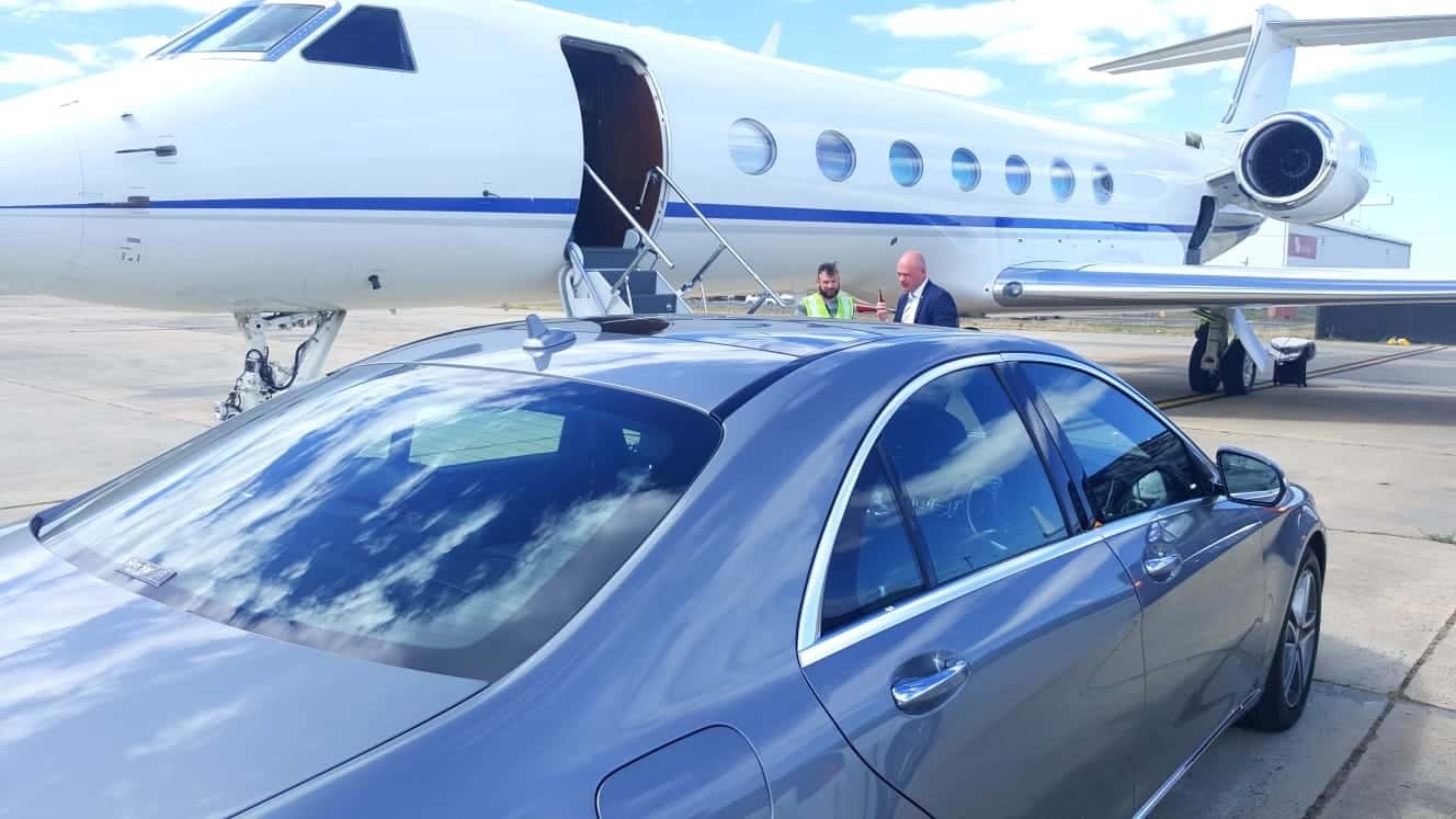 A luxury car and private jet.